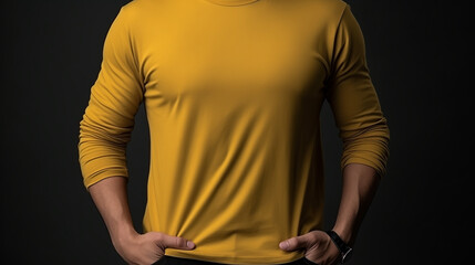 Man wearing yellow long sleeve t-shirt, isolated in dark background