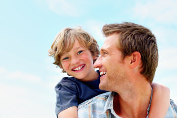 Obraz premium Father, son and smile outdoor with piggyback for bonding, relationship and freedom with blue sky in nature. Family, man and boy child with playing, care and love for excitement, peace and support