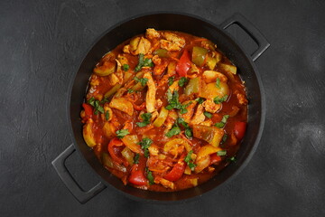 Chicken breast stew with vegetables and herbs and tomato sauce.