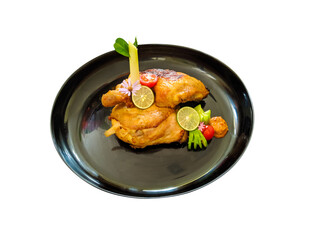 baked chicken served on black plate flat lay, isolated