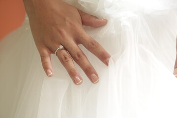 Obraz na płótnie Canvas wedding, hand, bride, hands, woman, ring, dress, manicure, love, beauty, nails, fingers, marriage, finger, nail, bridal, couple, holding, people, care, body, closeup, married, skin, ceremony