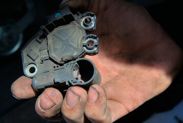 Car alternator regulator relay, worn brushes on the alternator. Car maintenance and servicing.