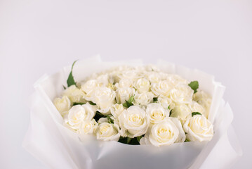 A bouquet of white roses. Flowers in a vase on the table. Wedding