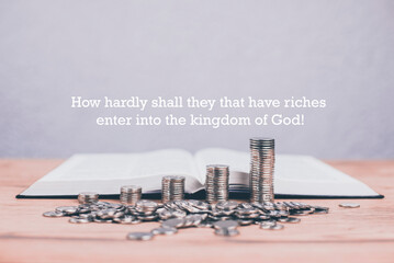 An open Bible on the table. Prayer. Stacks of coins in ascending order. Wealth. Investment and...