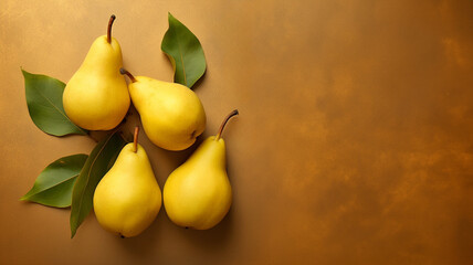 Ripe yellow pears on textured artistic background, top view.