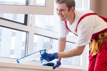 A repairman fixing windows in new apartment.