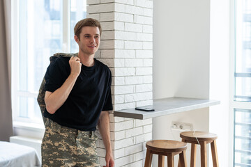Young soldier communicating at home.