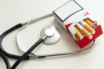 World no tobacco day. Close-up image of cigarette and stethoscope on white background.