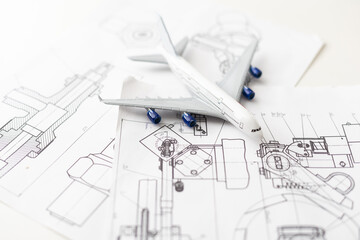Image of passenger airplane and engineering blueprint