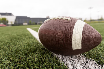 Leather football on a football field