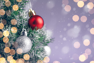 Close up of balls on christmas tree, golden garlands in the background.