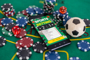 Smartphone and casino chips stacking on a green felt