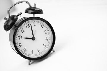 Black retro alarm clock on white background