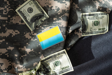 American dollars and Ukrainian hryvnia. The concept of the American aid to Ukraine in the war. The concept of the exchange rate.