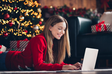 Photo of lying on carpet at home young woman brown hair teenager texting laptop her friends about received gifts in christmas midnight