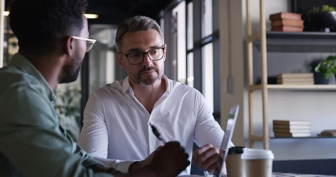 Business men, collaboration and laptop with web design management and communication at desk. Teamwork, staff and digital graphic discussion in a office with professional employee and work planning