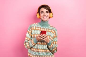 Photo of young girl bob brown hair using apple iphone connection orange bluetooth headphones device app isolated on pink color background