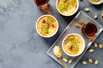 Baked rice pudding- traditional turkish milk dessert, served with pistachio nuts and cup of black...