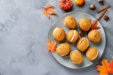Pumpkin  sandwich cookies with cream cheese filling. gray background, top view