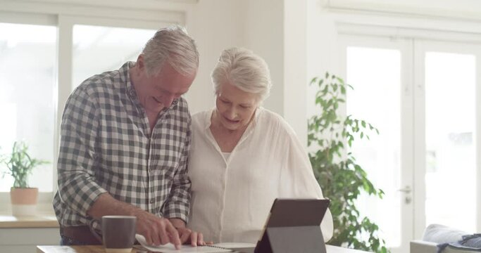 Senior couple, bills and documents on tablet for finance paperwork, taxes and mortgage or pension planning at home. Happy elderly people of asset management or budget in kitchen on digital technology
