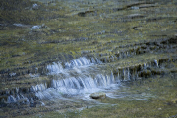 Waterfall over natural rocks