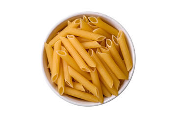 Raw penne pasta from whole grain wheat varieties with salt and spices