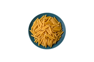 Raw penne pasta from whole grain wheat varieties with salt and spices