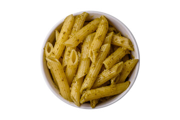 Delicious fresh pasta penne with green pesto sauce with basil, salt and spices