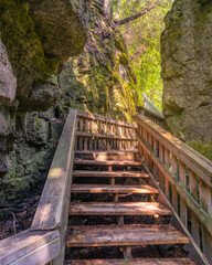 Picturesque wooden boardwalk and stairs on a hike through a canyon. Mono Cliffs Provincial Park, Ontario Canada