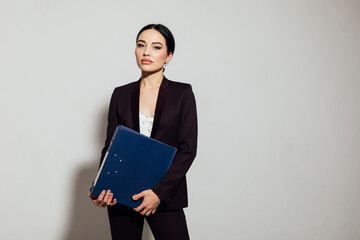 Woman in business suit with folders in office space