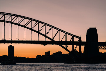 Harbour Bridge Silhouette of Sydney city landmarks side-view at sunset orange sky 