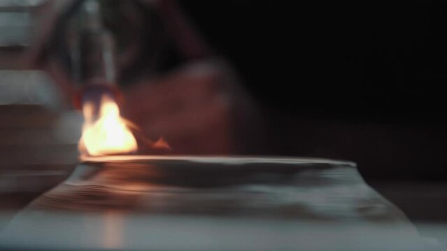 Roasting of a ceramic jug from a gas burner, close up. Flame is directed to clay dishes. Potter's work and creative process.