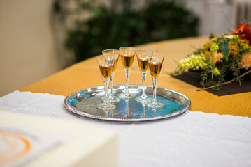 Five glasses on a stem with whiskey, rum, brandy. Luxurious serving of a beverage in a glass. Aperitif to welcome guests.