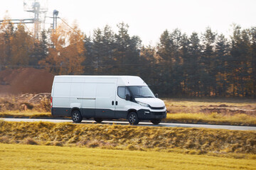 A commercial van truck on the highway, delivering goods and products across the country, using fast...
