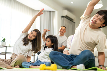 Portrait happy love asian fit strength family father and mother with little girl training sitting relax and practicing yoga, fitness, exercise, wellness, workout, sport at home.Diet.Fitness, healthy