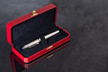 Fountain pen on marble and gray background. Gift concept.