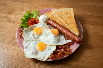 plate with typical american breakfast on wooden table