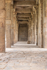 A walkway in the old Indian kutub minar complex. The vintage beams narrating the khalji dynasty history in India