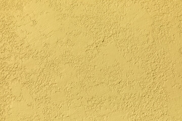 pattern of rough plaster wall painted in yellow