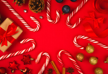 Christmas candy. Christmas composition with gifts, Christmas tree decorations on a red background. Concept for Christmas and New Year holidays. Winter. Flat lei, top view, copy space.