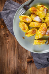 Homemade lazy noodles with cheese, crumbs and melted butter.