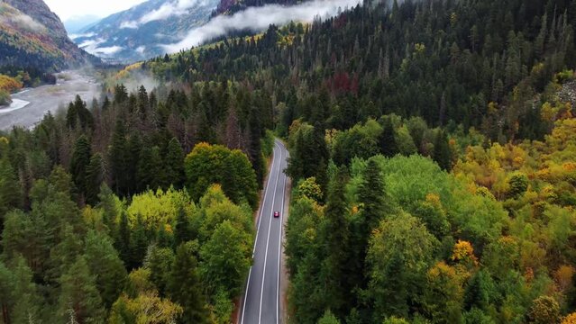 view of the mountain road in the autumn mountains of Dombai, the car is driving along the road