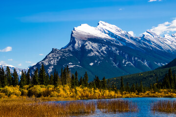 A scenic view of Rundle Mountain with Vermillion Lake in front in Banff, Alberta