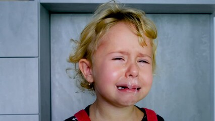 The child has snot. Selective focus.