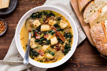 Creamy Zuppa Toscana soup served with sourdough bread.