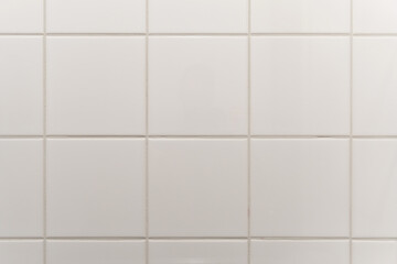 white tiled wall in the bathroom