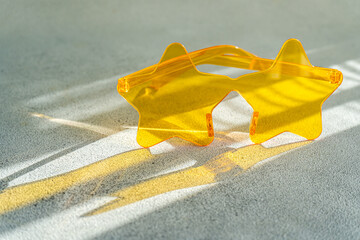 Close-up of a pair of yellow star shaped novelty glasses on a  table