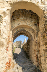 Fototapeta na wymiar Passageway with arches in ruined ancient fortress