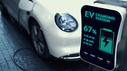 EV charging station display battery status interface for electric car, exemplifying green city with...