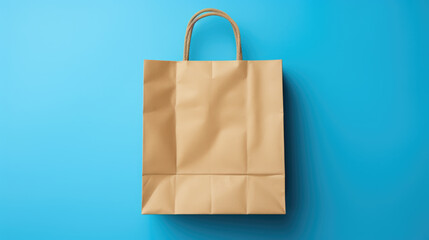 Plain brown paper shopping bag with a twisted rope handle, set against a bright blue background. - obrazy, fototapety, plakaty